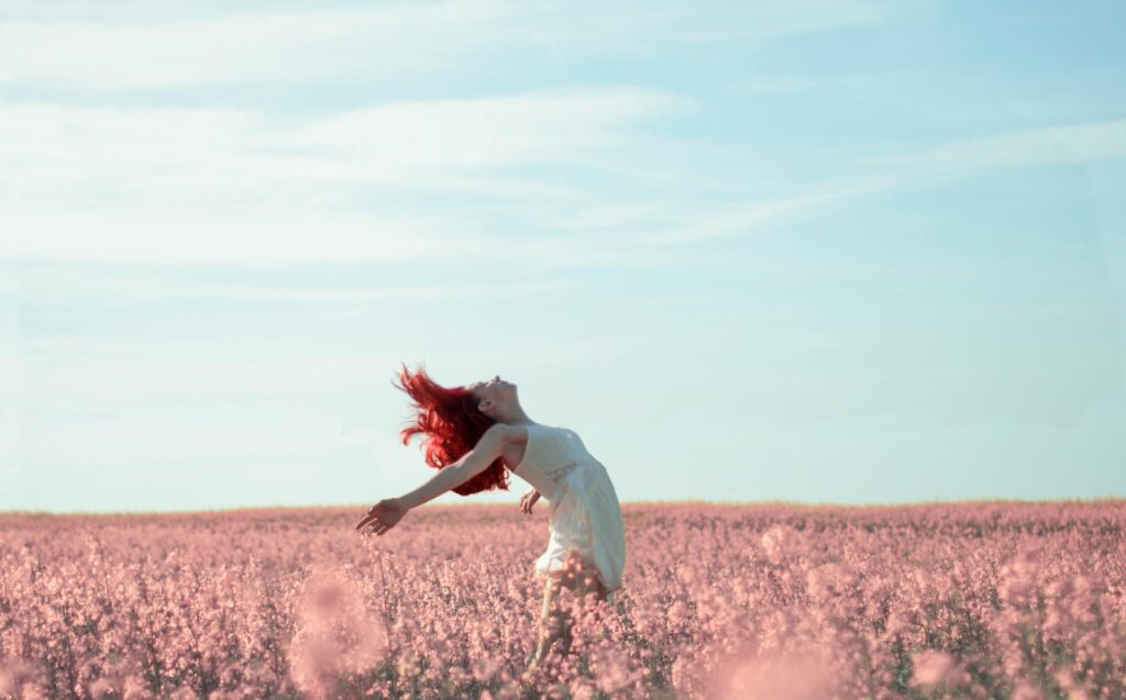 Woman in Yellow Dress Standing on Pink Petaled Flower Field